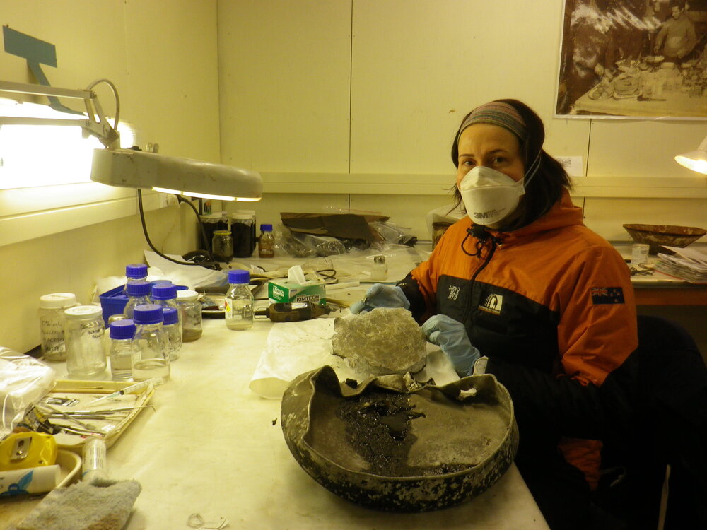 2014 AHT's Meg Absolon with Nansen cooker part, winter conservation lab, Scott Base