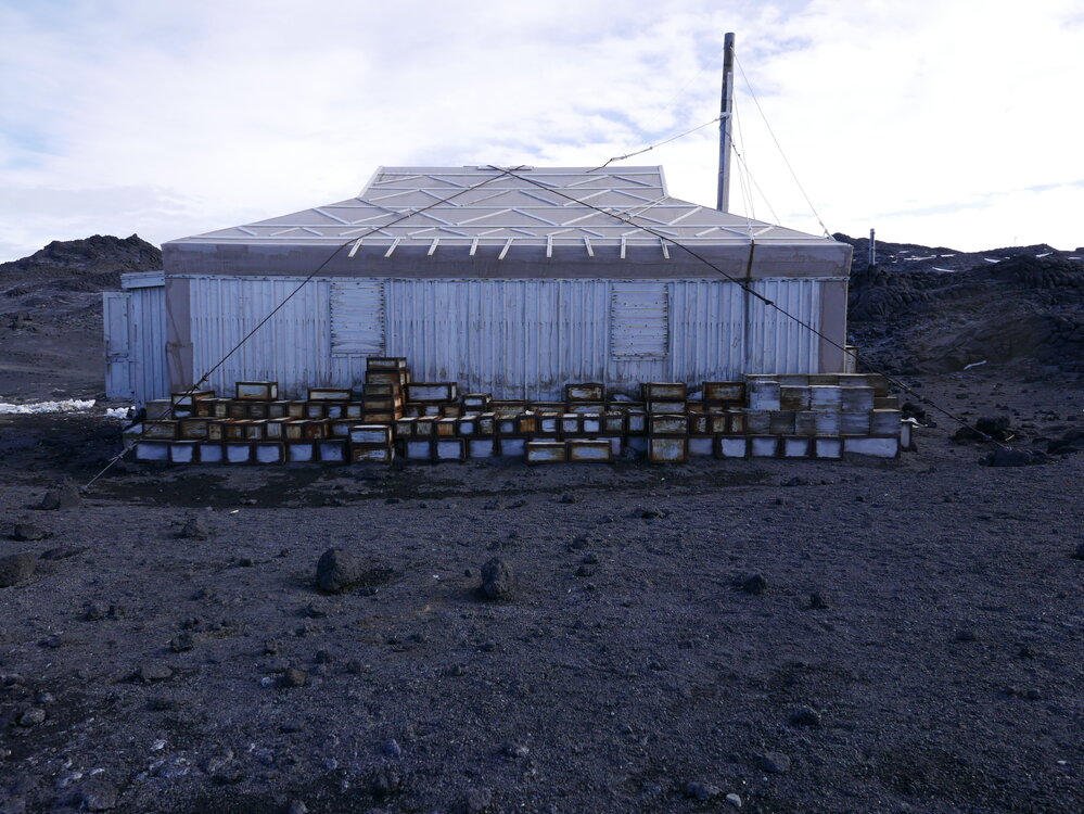 2018-19 Venesta cases stacked outside Shackleton's 'Nimrod' hut, Cape Royds