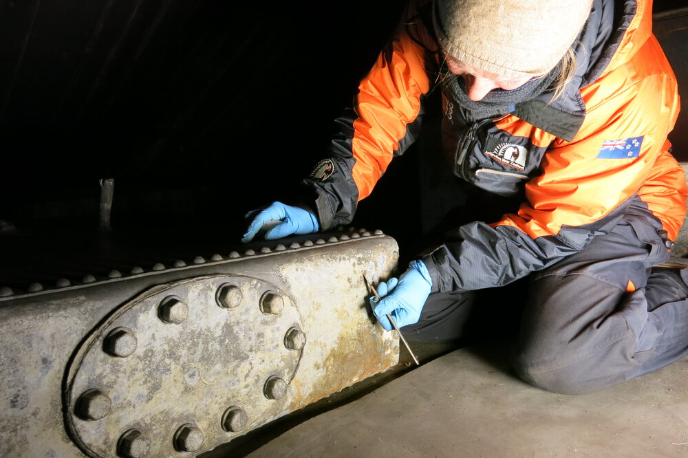 2013-14 Conservators at work. Nicola Dunn treating the water tank, Cape Evans (003)