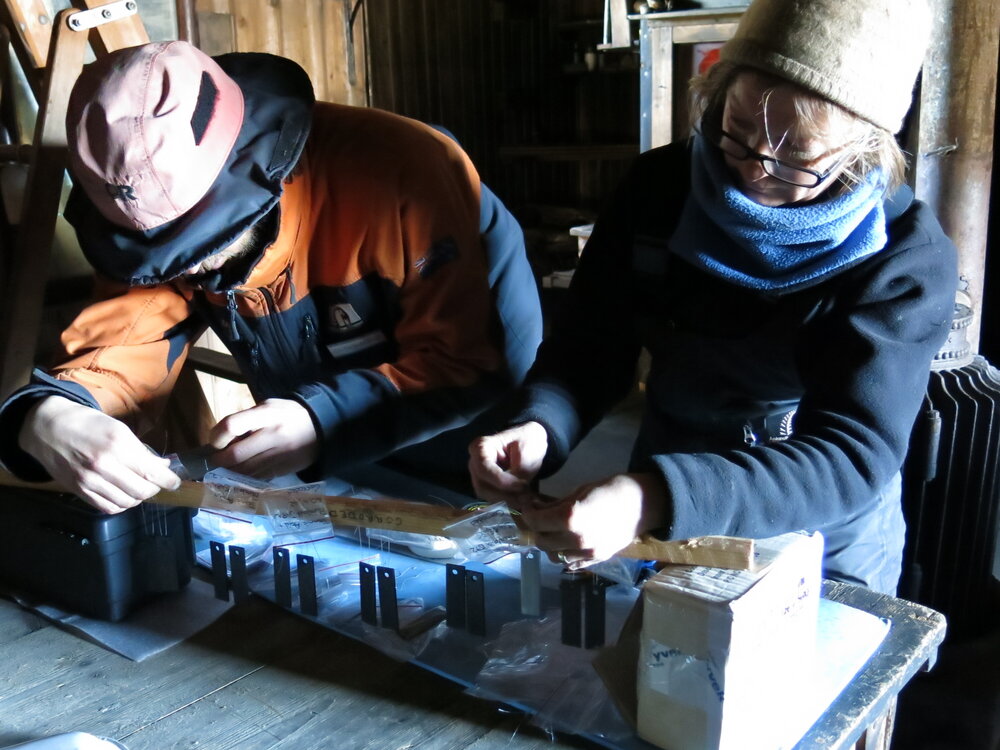 2013-14 Josiah Wagener and Nicola Dunn retying Quest coupons, Cape Evans