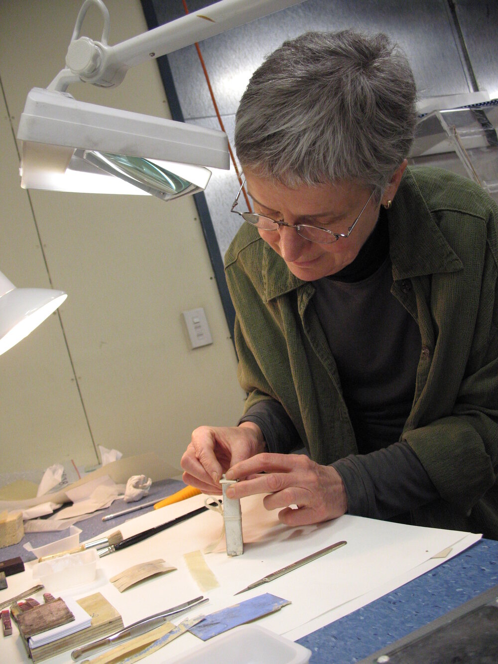 AHT Conservator Therese Charbonneau treating a cardboard box