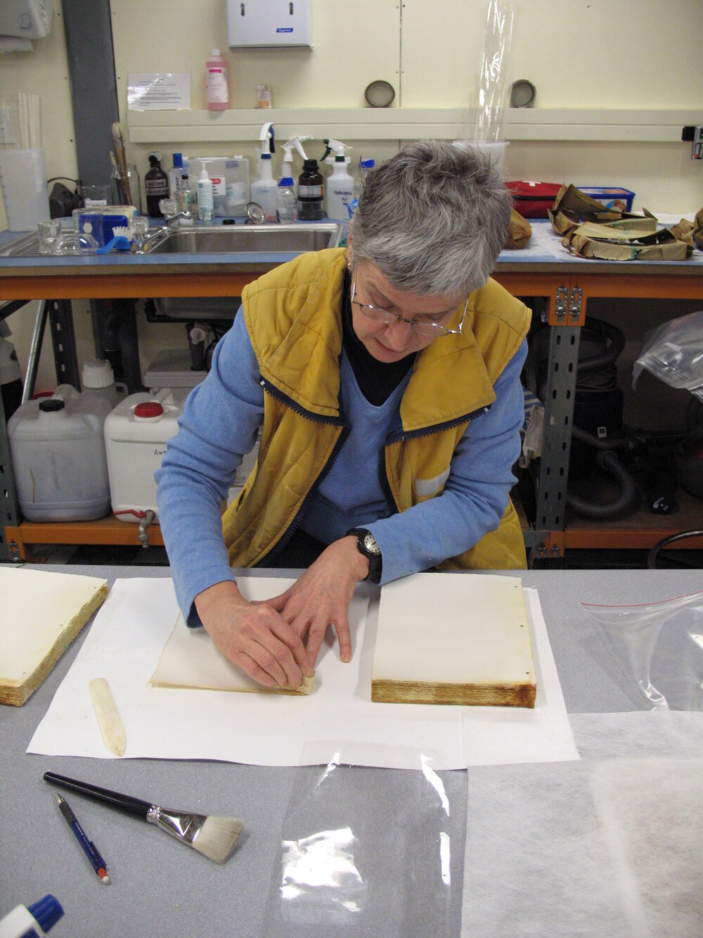 AHT Conservator Therese Charbonneau working on Aurora Australis paper