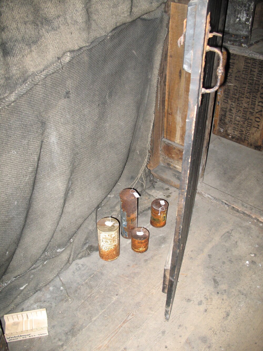 Corroded tins of food with coating applied, Scott's 'Discovery' Hut (002)