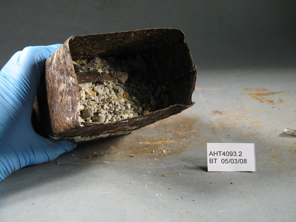 Before Treatment image - Corroded tin and contents