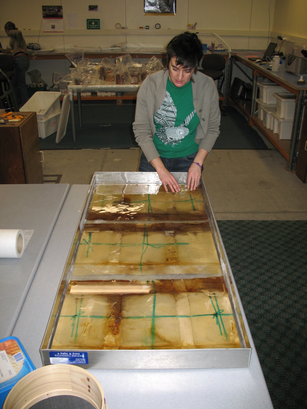 AHT Conservator Lizzie Meek working on Aurora Australis paper