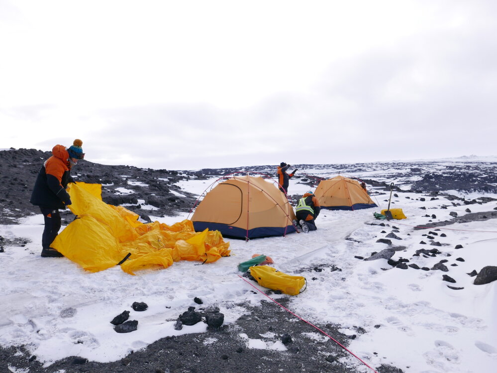2017-18 Antarctic Heritage Trust conservation team members pitching Cape Royds field camp tents