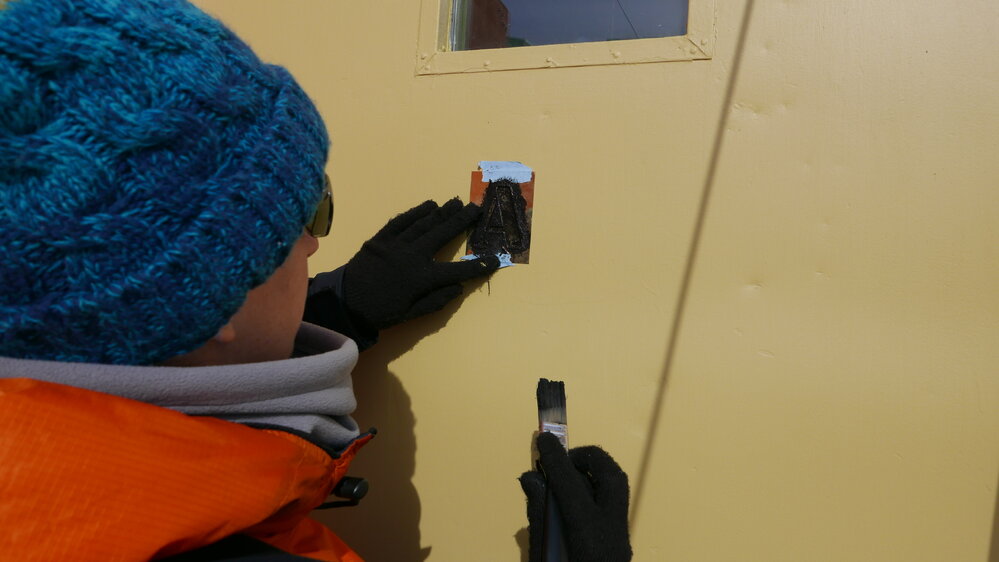 2017-18 Hillary's TAE/IGY hut, work task, AHT's Diana McCormack stencilling exterior wall panels