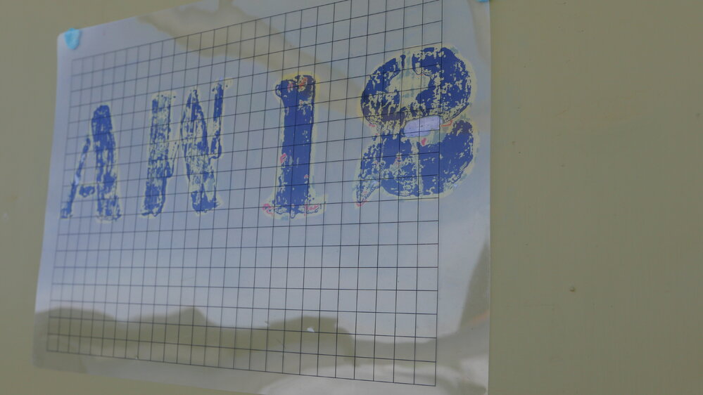 2017-18 Hillary's TAE/IGY hut, work task, original stencilling on exterior wall panel