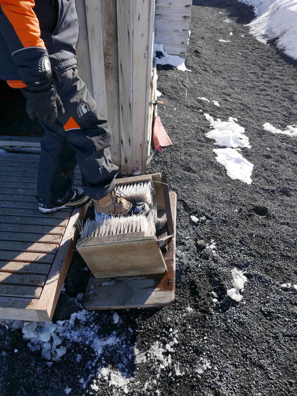 2018-19 Using the shoe brush outside Scott's 'Terra Nova' hut, Cape Evans