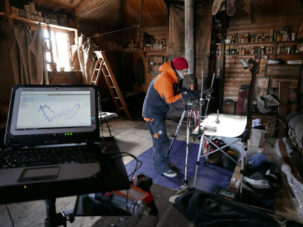 2018-19 Nicola Stewart photographing artefacts inside Shackleton's 'Nimrod' hut