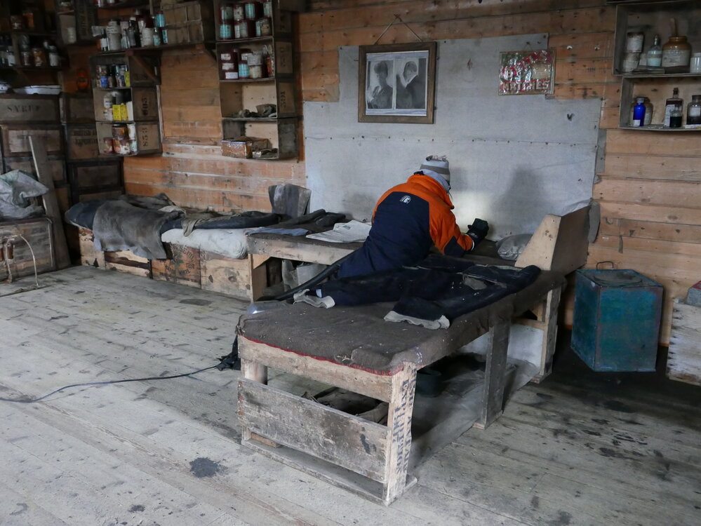 2018-19 Nicola Stewart vacuuming inside Shackleton's 'Nimrod' hut, Cape Royds