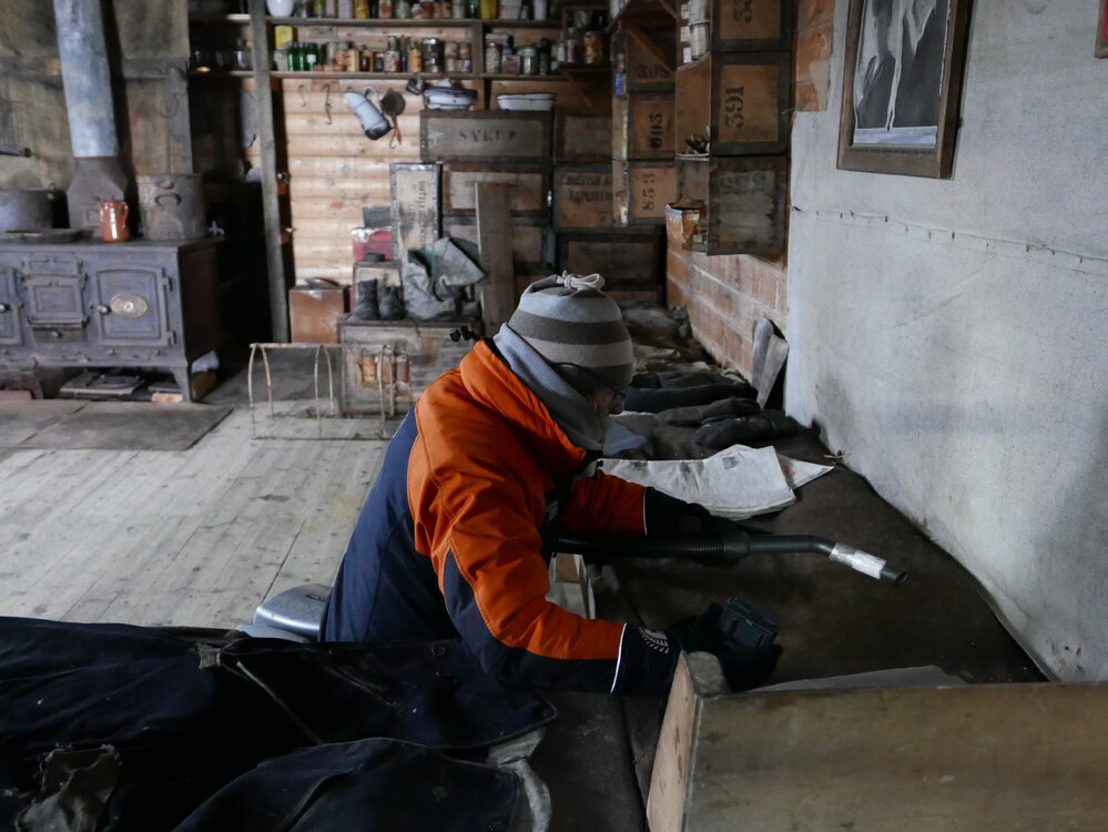 2018-19 Nicola Stewart vacuuming inside Shackleton's 'Nimrod' hut, Cape Royds