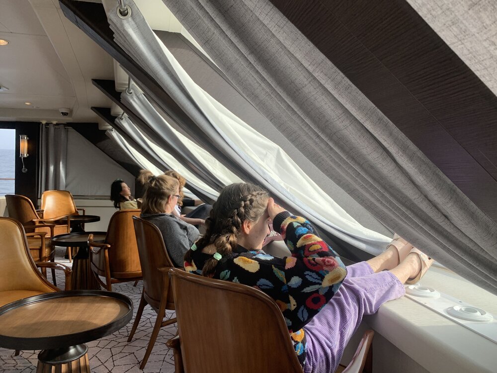 Inspiring Explorers look out the windows of the 'Magellan Explorer'