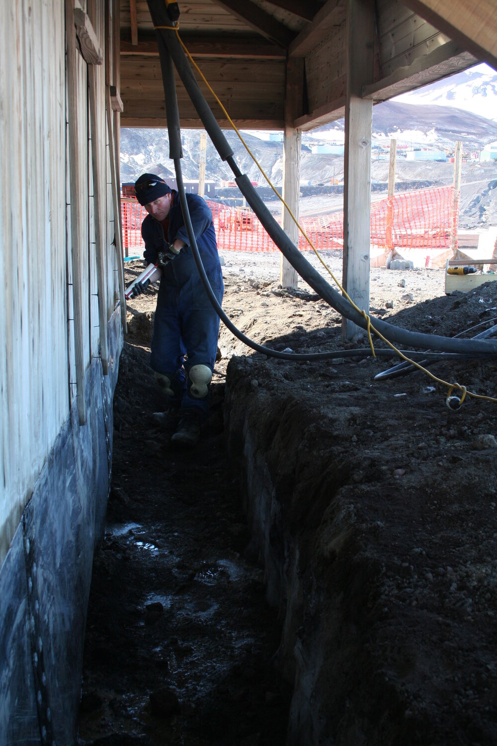 2013-14 Mark Adams working outside Scott's 'Discovery' hut, Hut Point