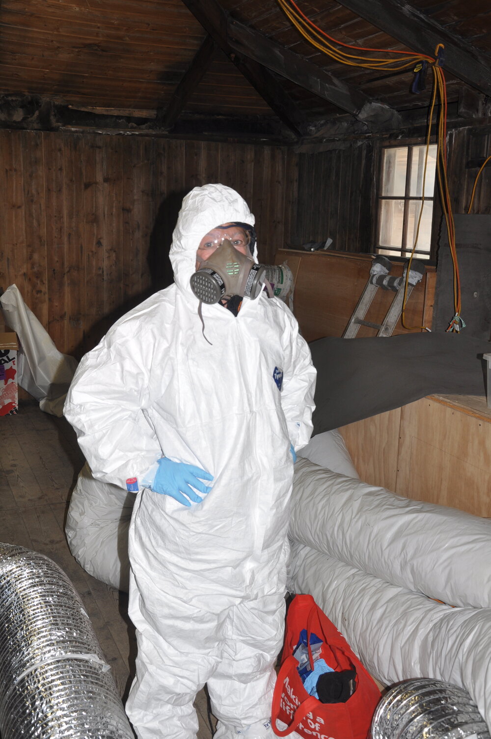 2013-14 Nicola Dunn in PPE inside Scott's 'Discovery' hut, Hut Point