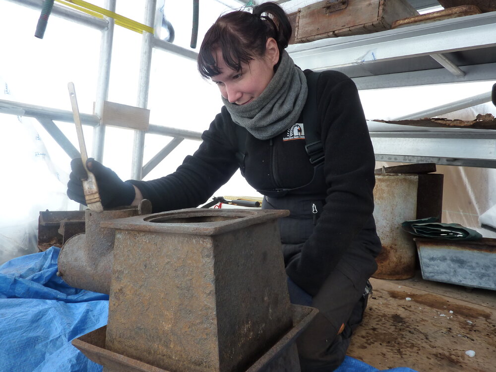 2009-10 AHT's Fran Clarke treating Stables blubber stove, Cape Evans