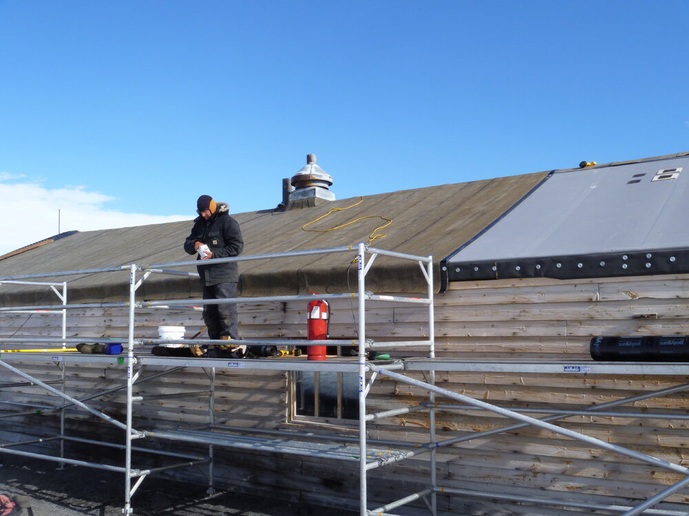2010-11 John Taylor on scaffolding, Cape Evans