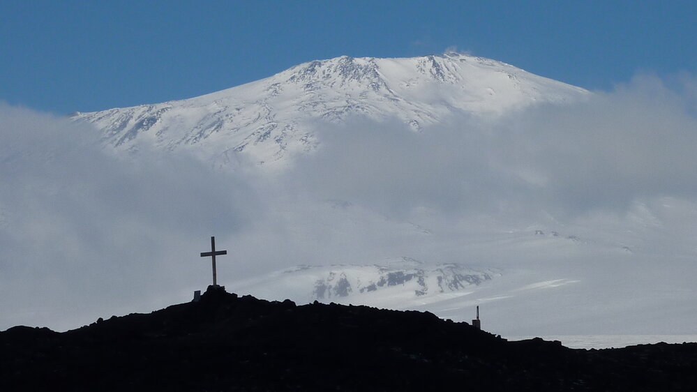 2010-11 Wind Vane Hill Cross silhouette against Mount Erebus