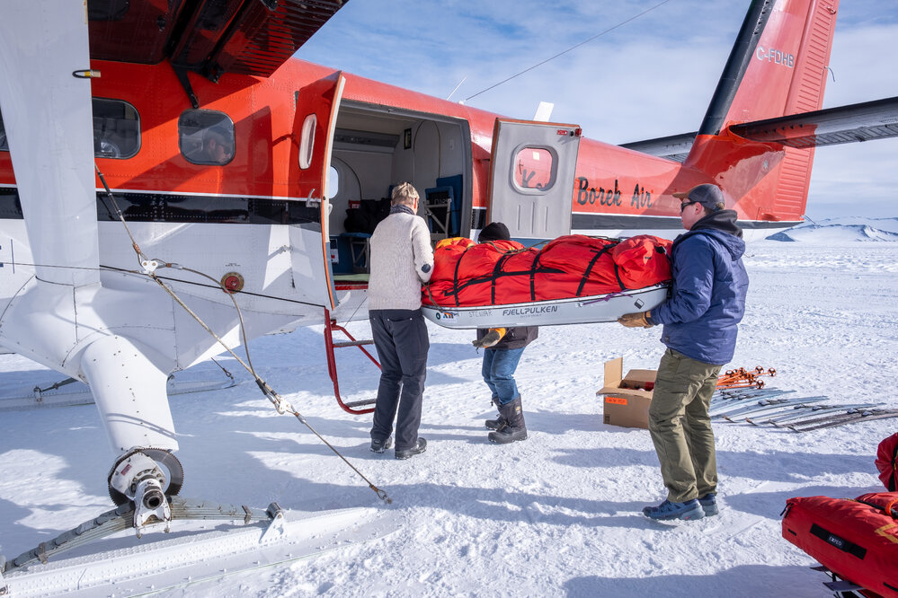 ALE staff load the Inspiring Explorer team's equipment into a plane