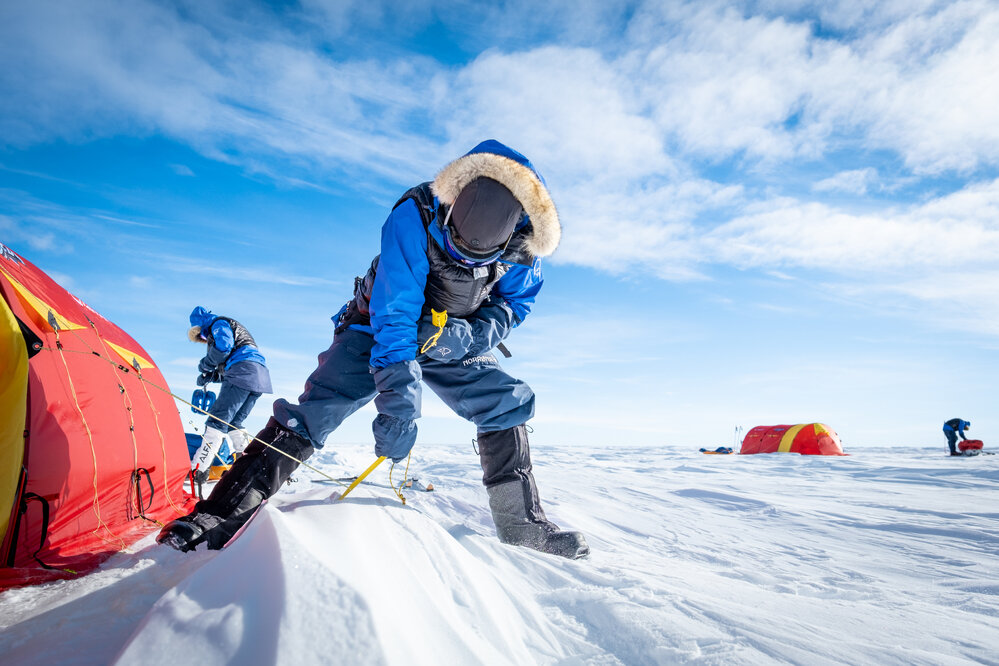 Mike Dawson pitching a tent on the South Pole Expedition