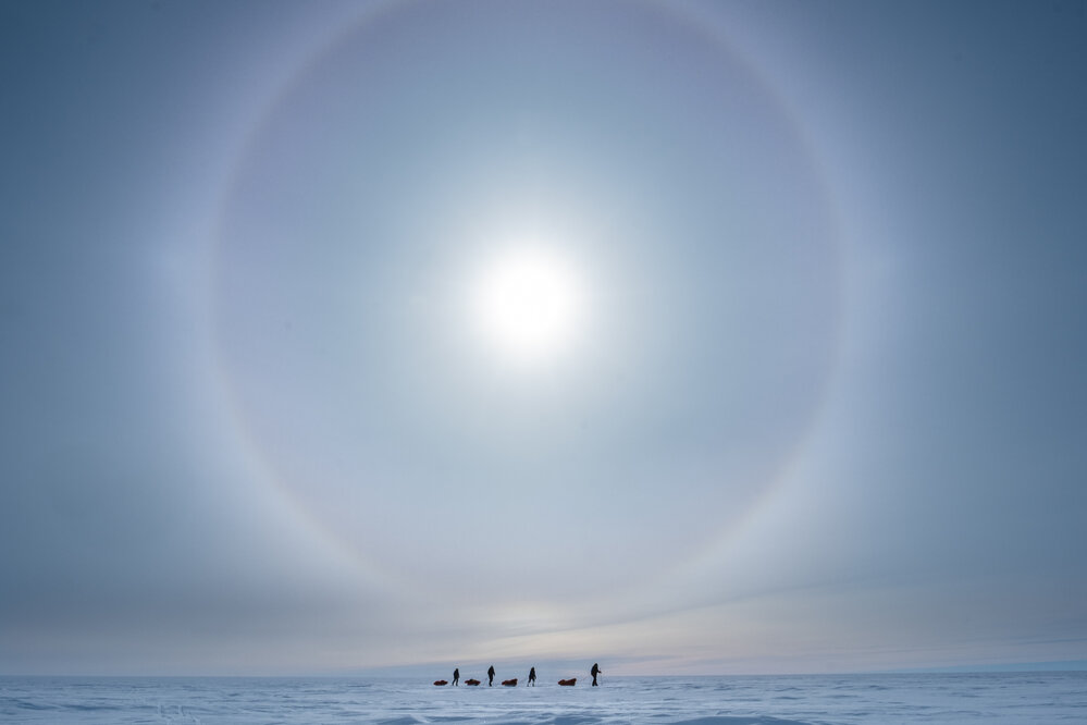Inspiring Explorers Expedition&trade; team below a sun dog on the South Pole Expedition