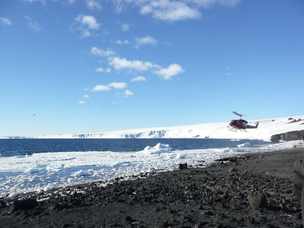 Helicopter arriving at Cape Evans
