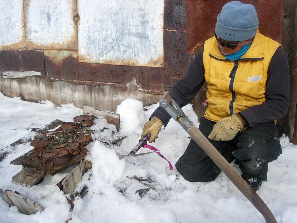 Heritage Carpenter Ted Bugg extracting a box from snow and ice