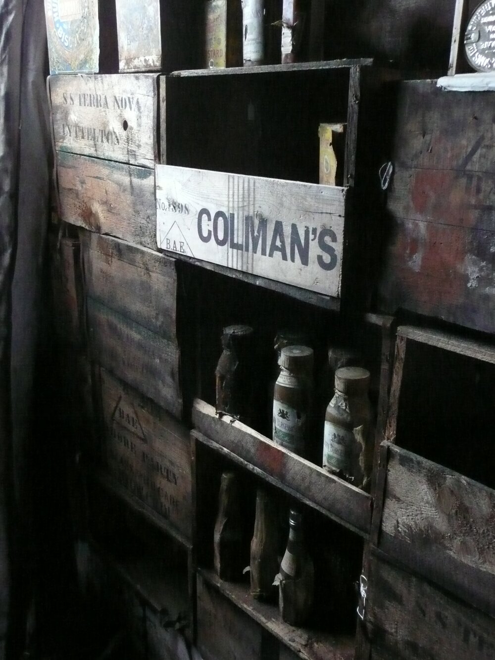 Bulkhead made of provision boxes and stocked with artefacts