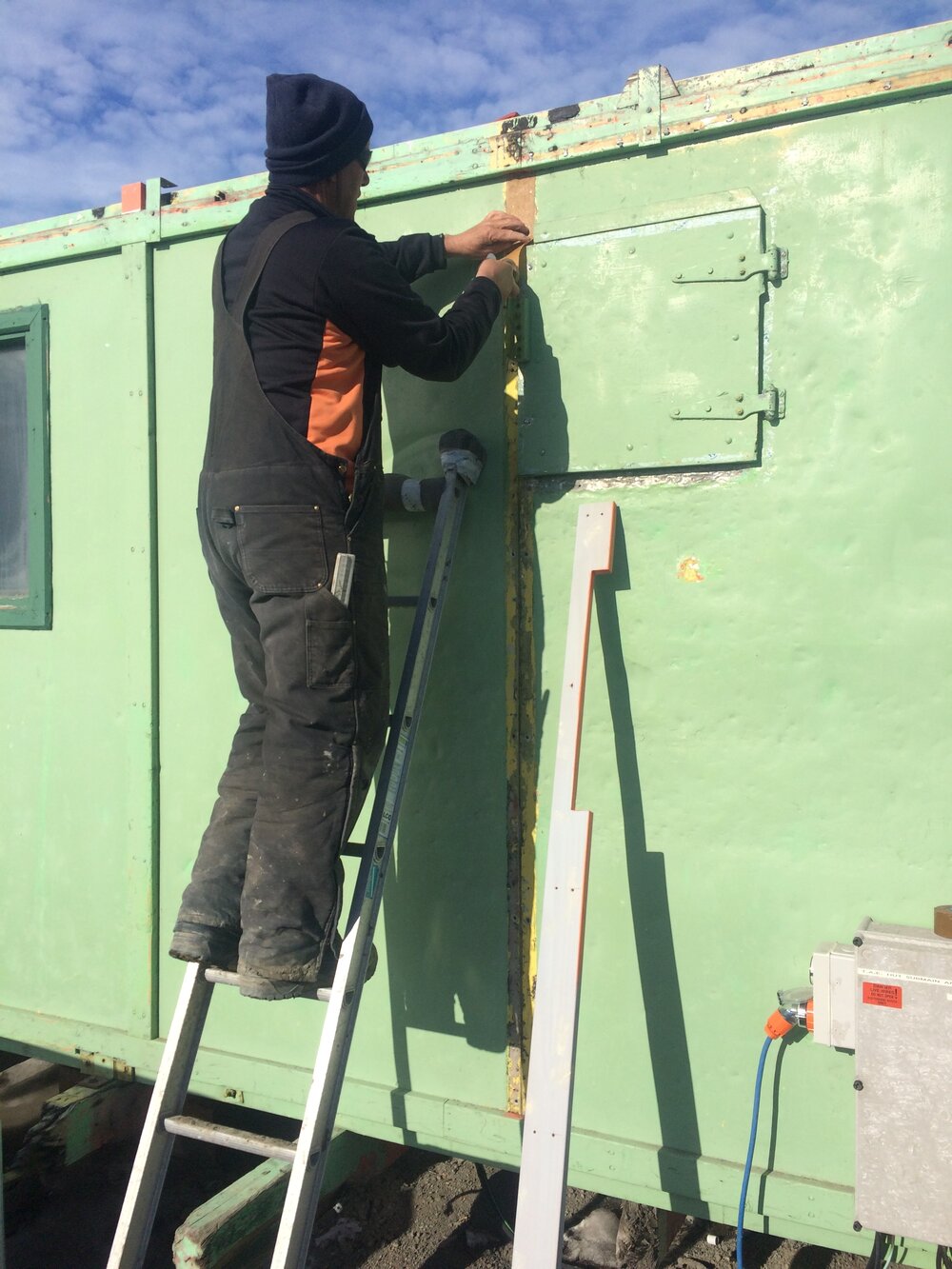 2016-17 AHT's Doug Henderson working on the exterior of Hillary's TAE/IGY hut, Scott Base