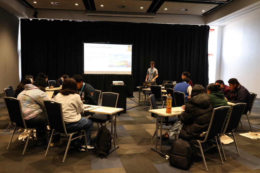 2023 Owain John with students at the Explorer Conference