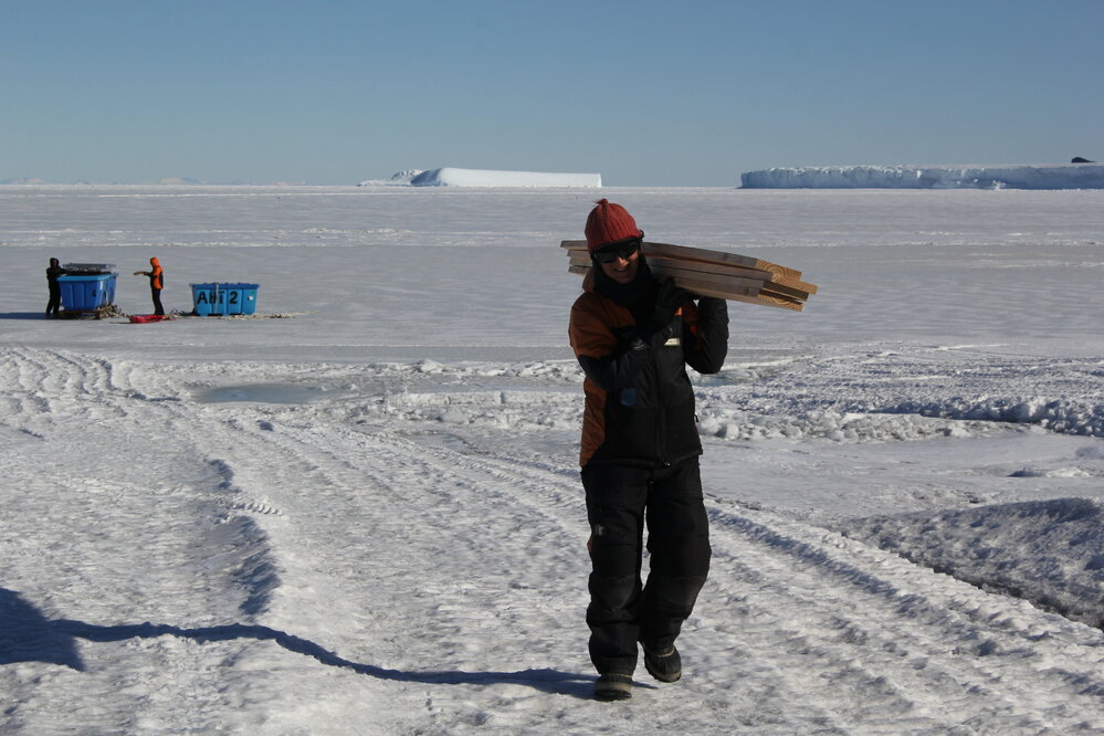 2018-19 Lizzie Meek carrying wood supplies, Cape Evans (001)