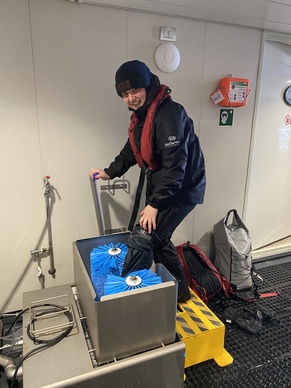 Inspiring Explorer Lily Green cleans her shoes on board the 'Magellan Explorer'