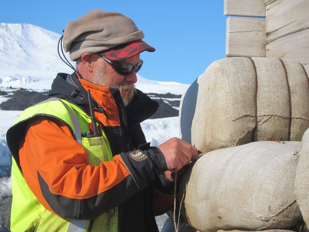 Programme Manager Al Fastier working on fodder bales, Scott's 'Terra Nova' hut (001)