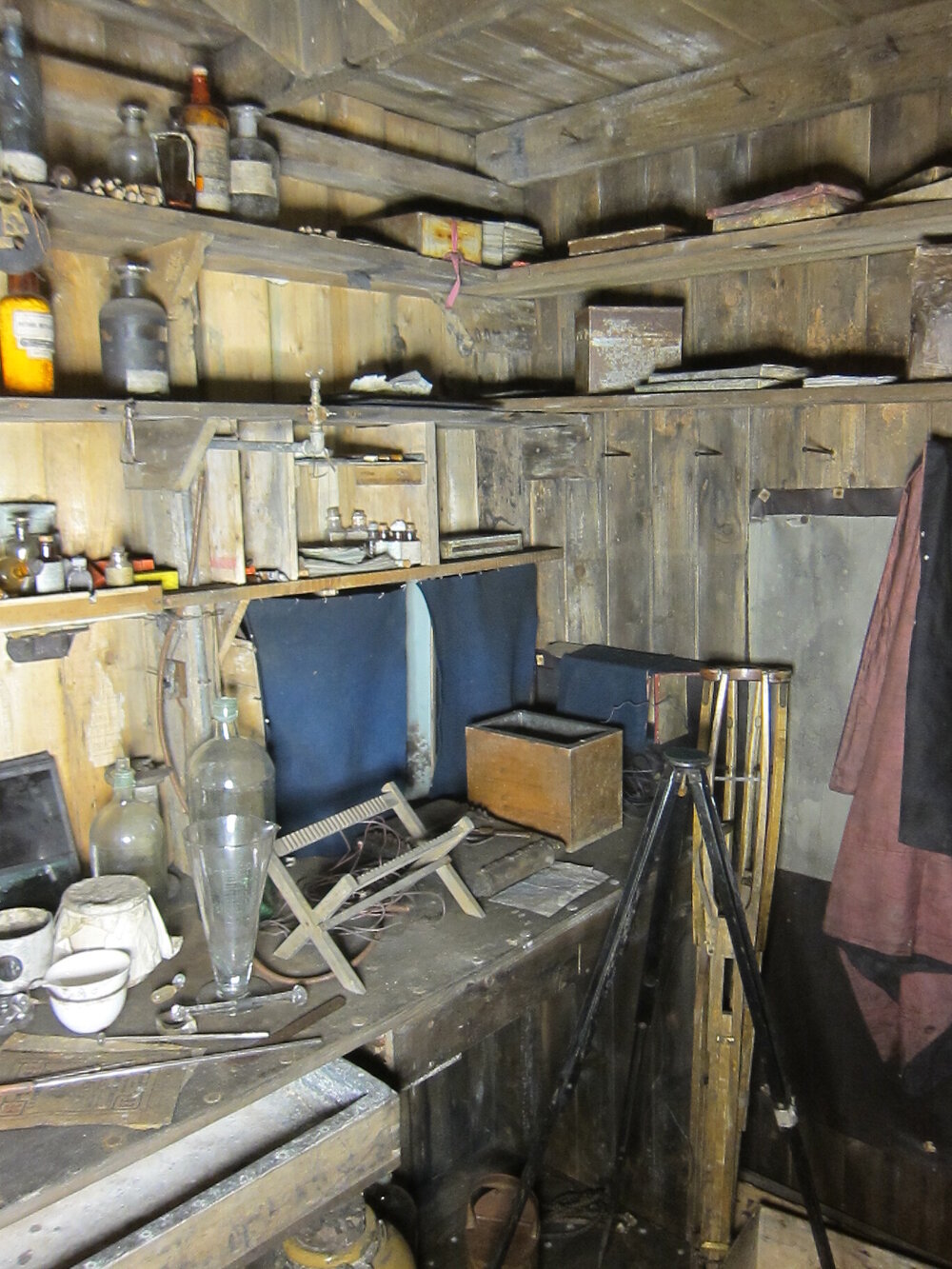 Artefacts on shelves and bench, Darkroom of Scott's 'Terra Nova' hut (002)