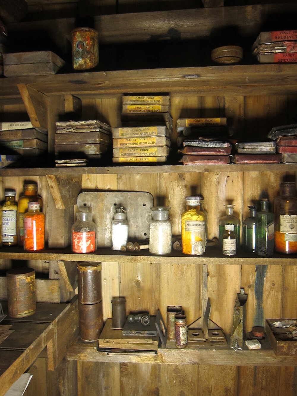 Photographic artefacts on shelves, Darkroom of Scott's 'Terra Nova' hut (001)