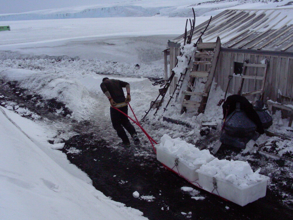 Man hauling snow away during snow removal