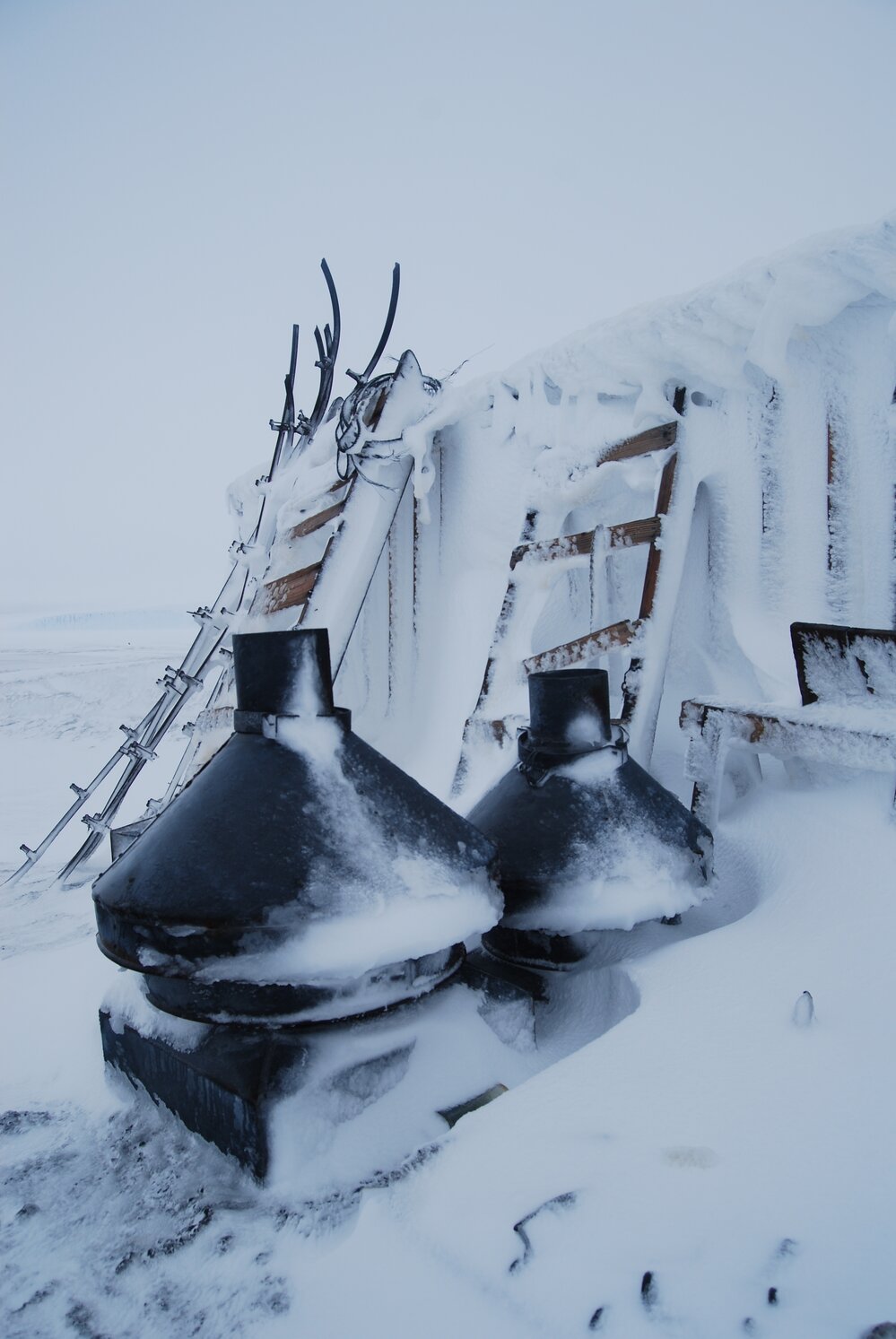 Snow build-up on flue parts and sleds on west wall (001)