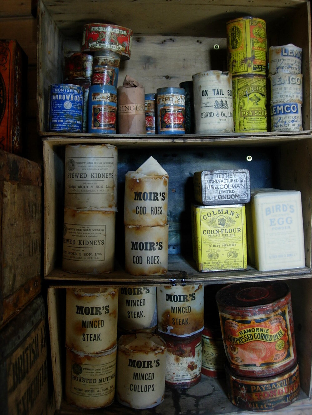 Tinned food artefacts on shelf in Scott's 'Terra Nova' hut