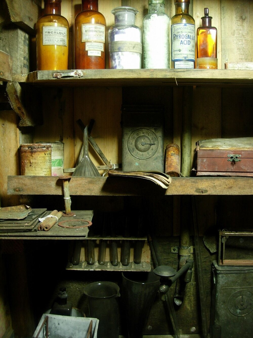 Chemical bottles, beakers and equipment on shelves in the Darkroom