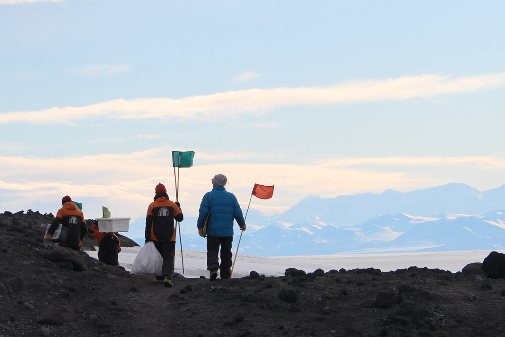 Summer team with flags and cargo, Cape Evans