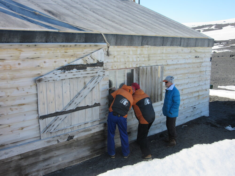 Inspecting window 4, Scott's 'Terra Nova' hut