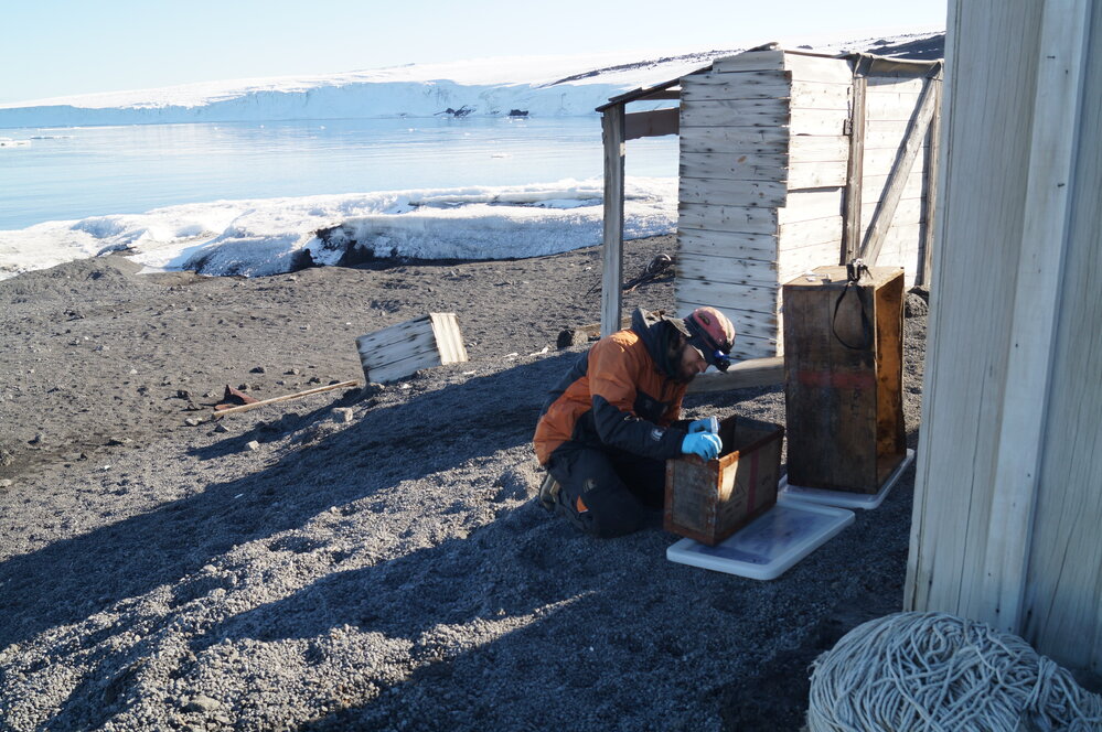 2013-14 Josiah Wagener treating cases outside Scott's 'Terra Nova' hut, Cape Evans (001)