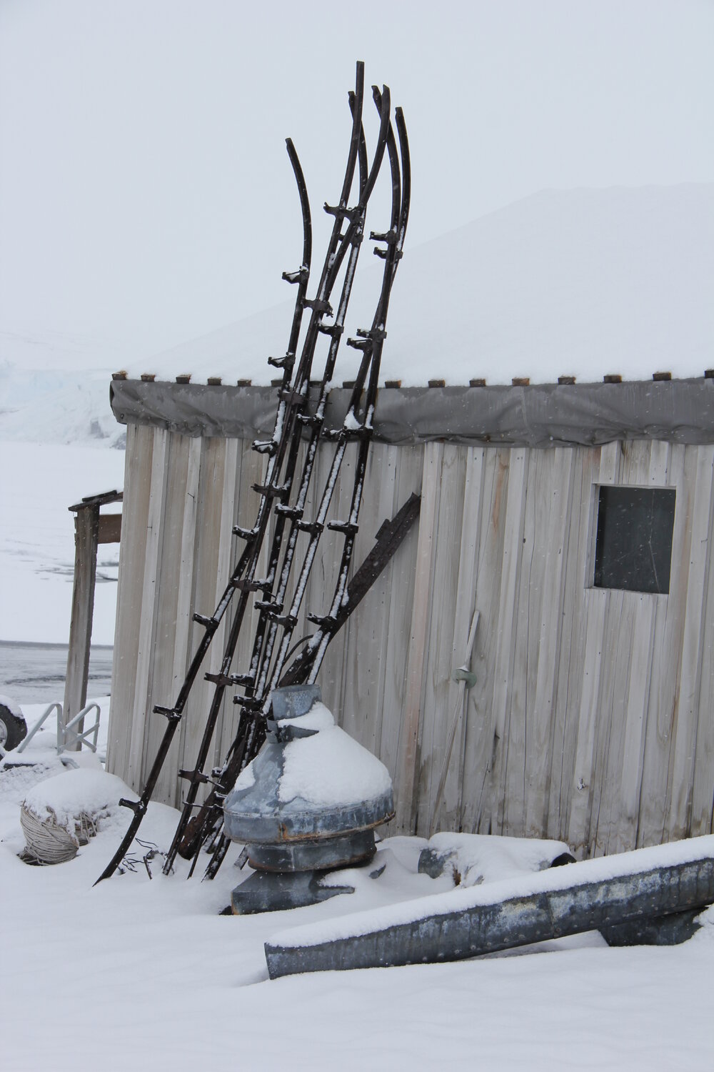 2022 Scott's 'Terra Nova' hut, exterior detail, West wall artefacts during snowfall