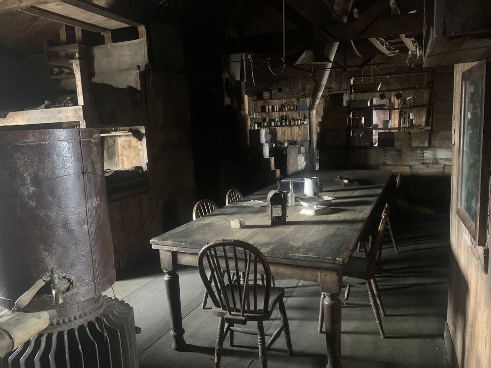 2022 Scott's 'Terra Nova' hut, interior, Wardroom table, looking West (002)