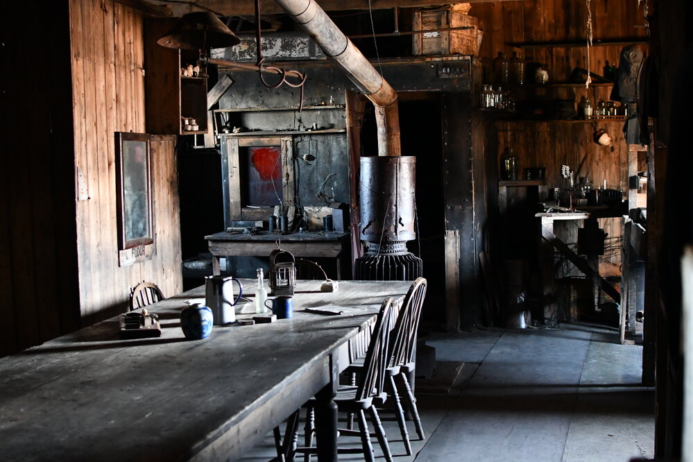 2022 Scott's 'Terra Nova' hut, interior, Wardroom table, stove, and Darkroom