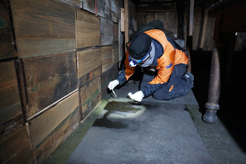 2022 Scott's 'Terra Nova' hut, work task, AHT conservator cleaning oil leak (002)