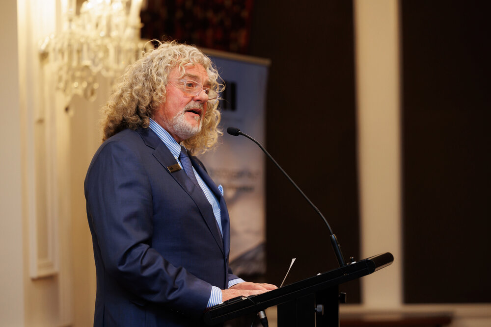 Board Chair Mark Stewart addresses guests