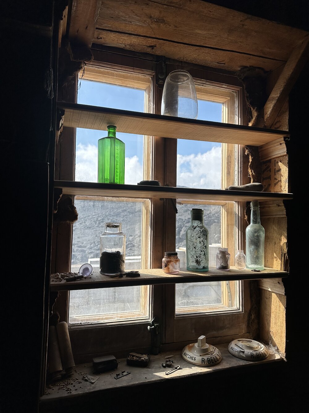 2025-26 Artefacts in the window, Shackleton's 'Nimrod' hut, Cape Royds