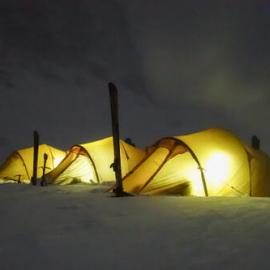 The tents of inspiring explorers glow as they settle in for the night while camping in South Georgia