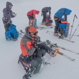 Members of the Antarctic Heritage Trust Inspiring Explorers Expedition™ taking a break in unpleasant windy conditions on their crossing of South Georgia